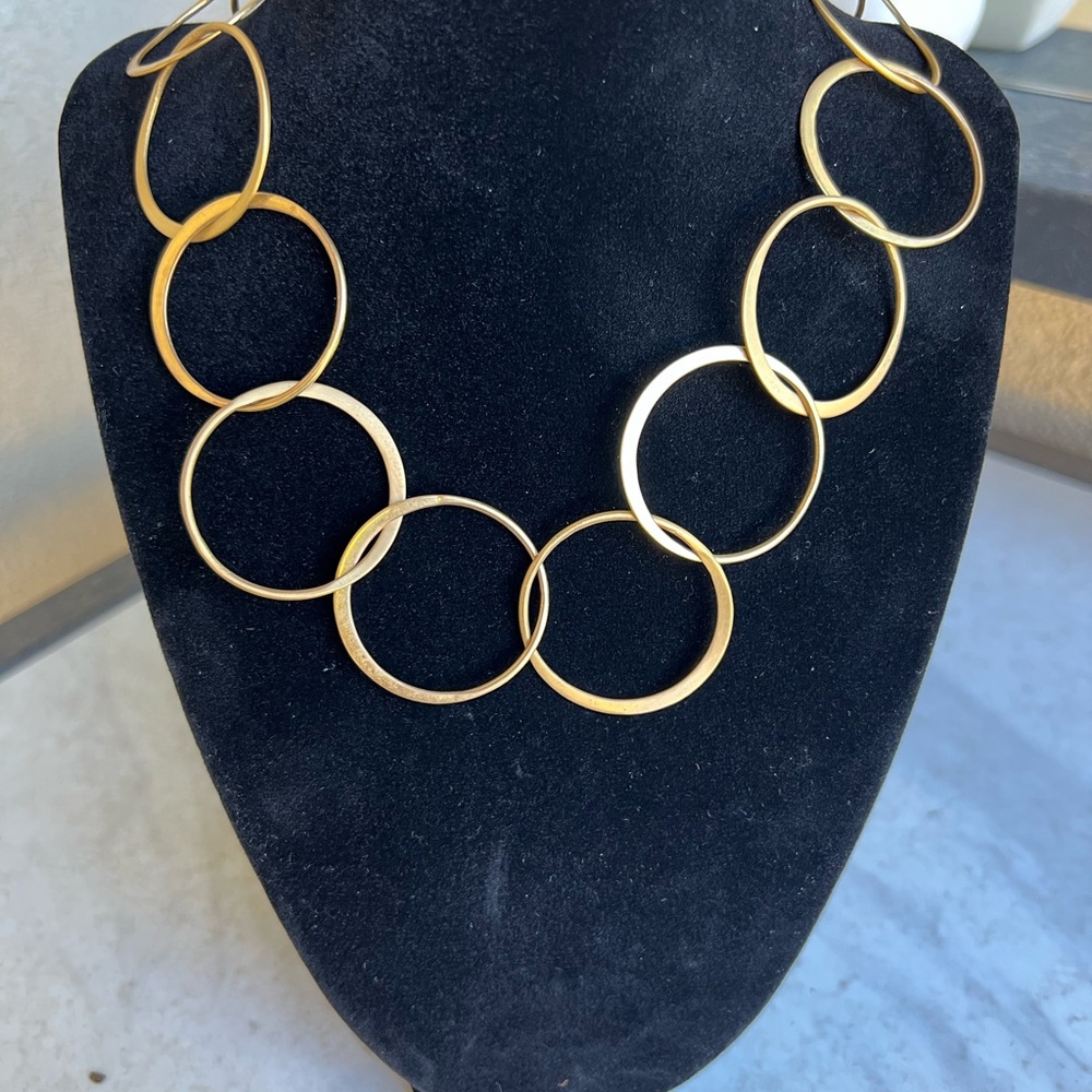 Gold necklace with interlocking circles.